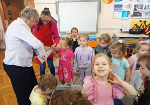 Dzieci z grupy Małpek podczas otwierania paczek z zabawkami.